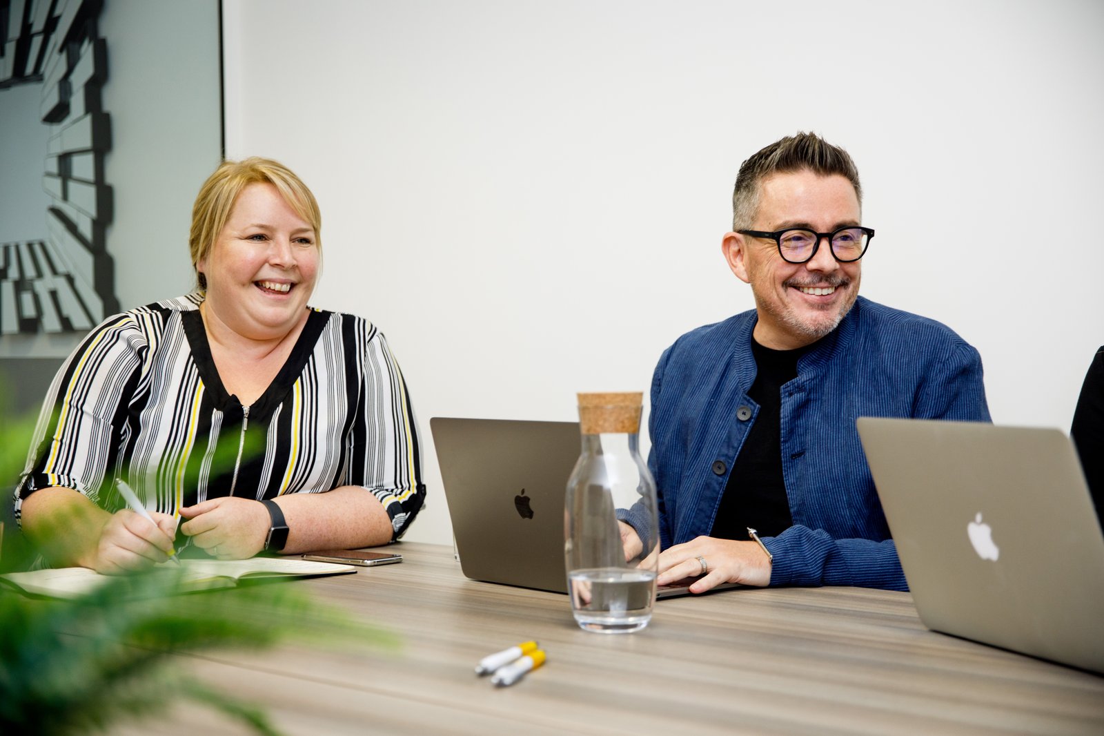 Seren leadership team laughing during a meeting in Cardiff